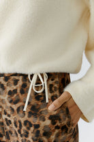 Close-up of drawstring hem on oui fluffy knit cream jumper.