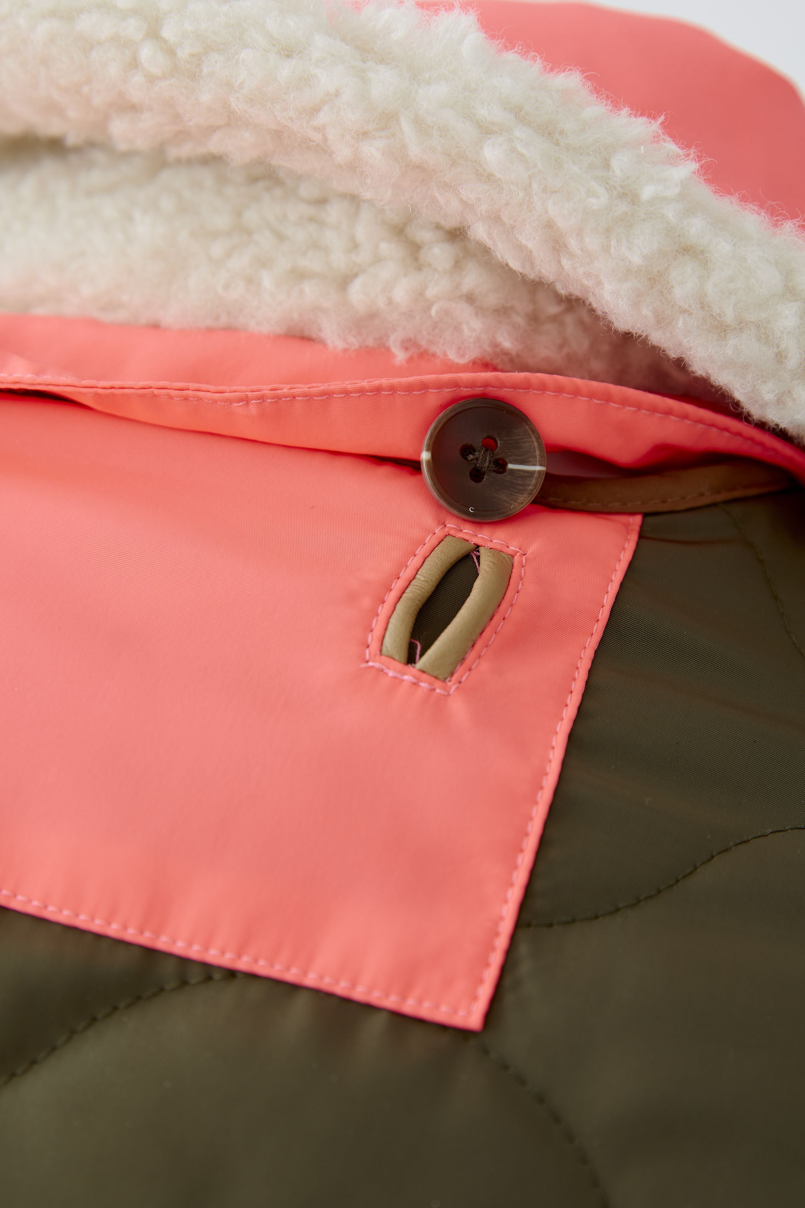 Oui reversible khaki jacket — close-up of metal zip and contrast trims.