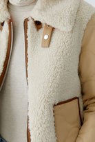 Oui reversible tan and cream jacket — close-up of cosy detachable collar and buckle tab.