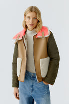 Oui reversible jacket — front view, tan faux-leather side with khaki quilted sleeves and neon collar tab.