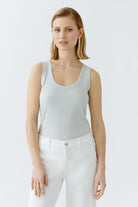 Model wearing slim-fit grey shimmer tank by Oui