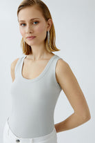 Oui grey tank top styled with bouclé jacket and denim