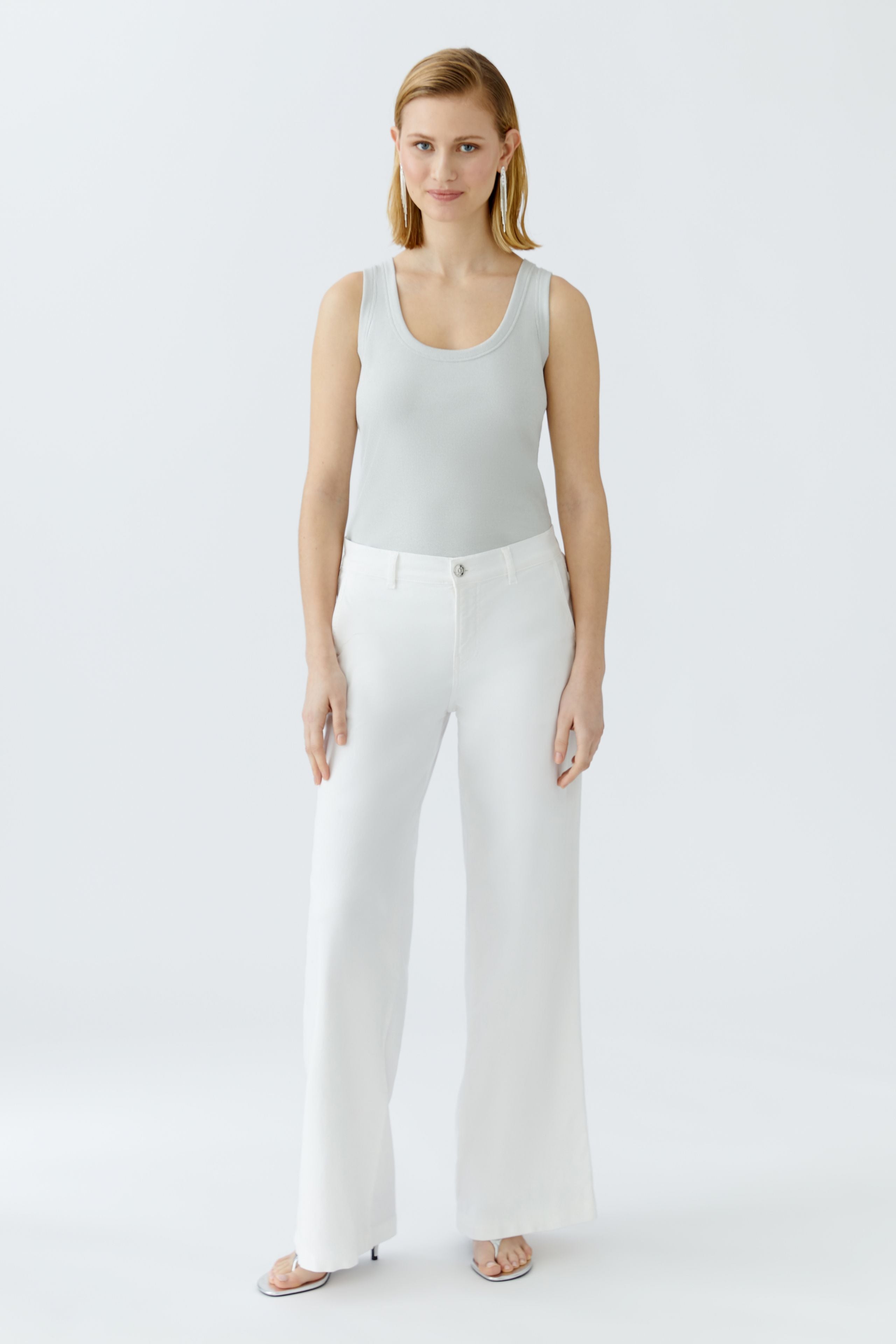 Oui grey ribbed tank top with deep neckline styled with white trousers