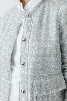 Close-up of Oui jacket’s statement button and sequin detail