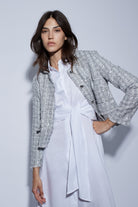 Model in white shirt dress layered with Oui cropped summer jacket