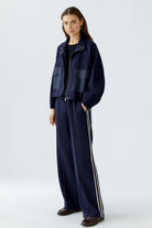 Full look with model in matching Oui jacket and trousers, hands in pockets