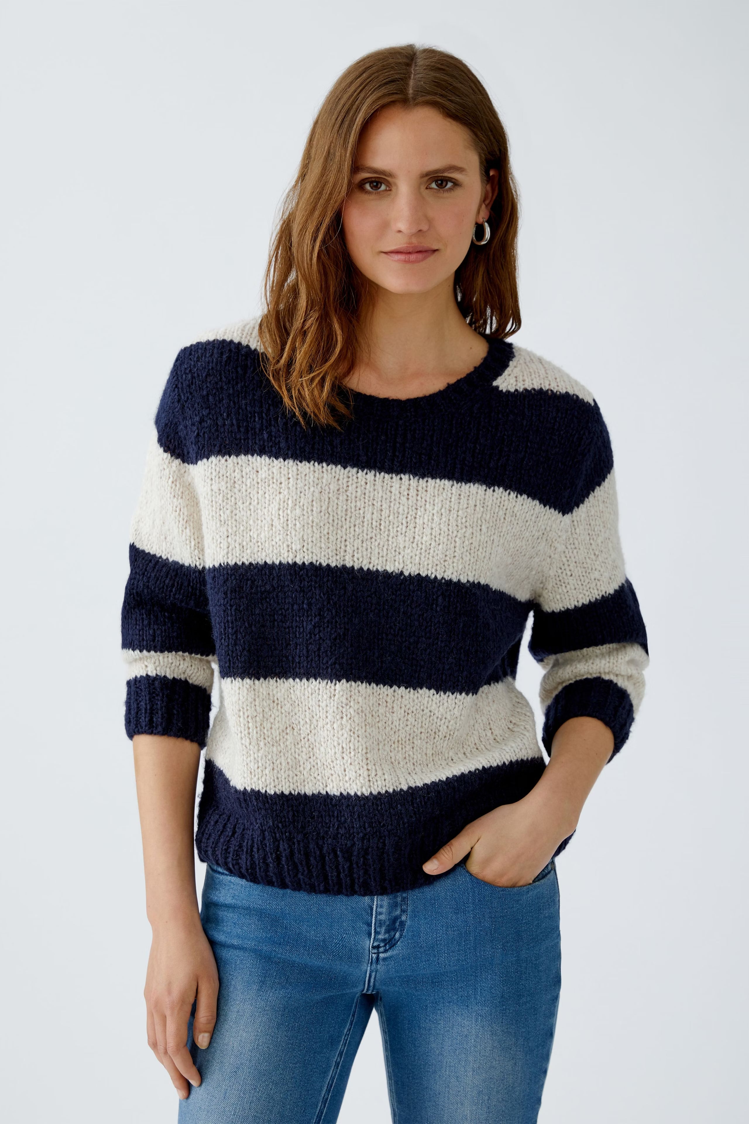 Model wearing striped wool blend jumper in navy and cream