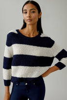 Model styling Oui Esmy navy and cream striped jumper with dark blue jeans