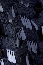 Close-up view of matte and glossy sequin detail on navy cam