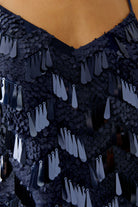Close-up of neckline and sequin finish on Oui navy cami Top