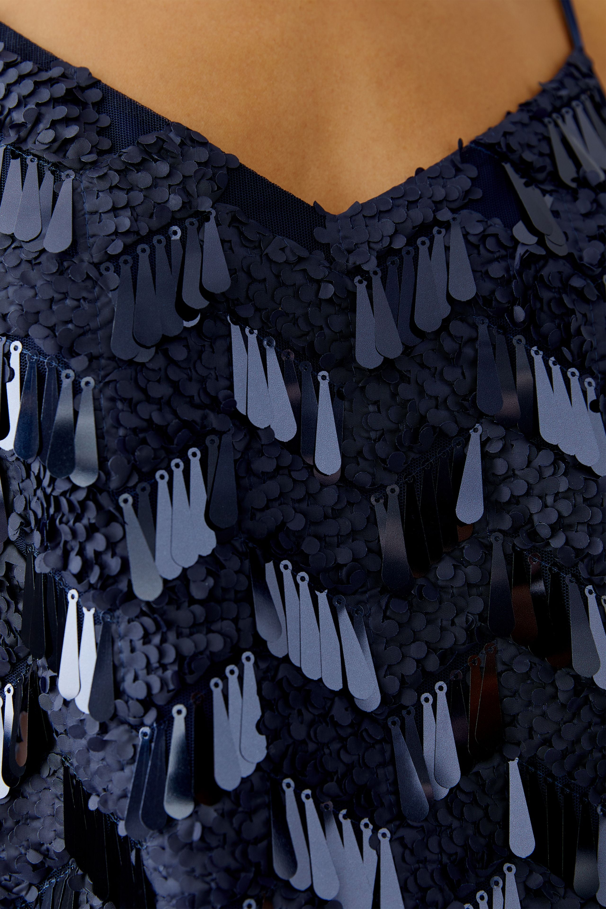 Close-up of neckline and sequin finish on Oui navy cami Top