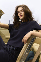 Lifestyle shot featuring navy cami layered under relaxed navy tee