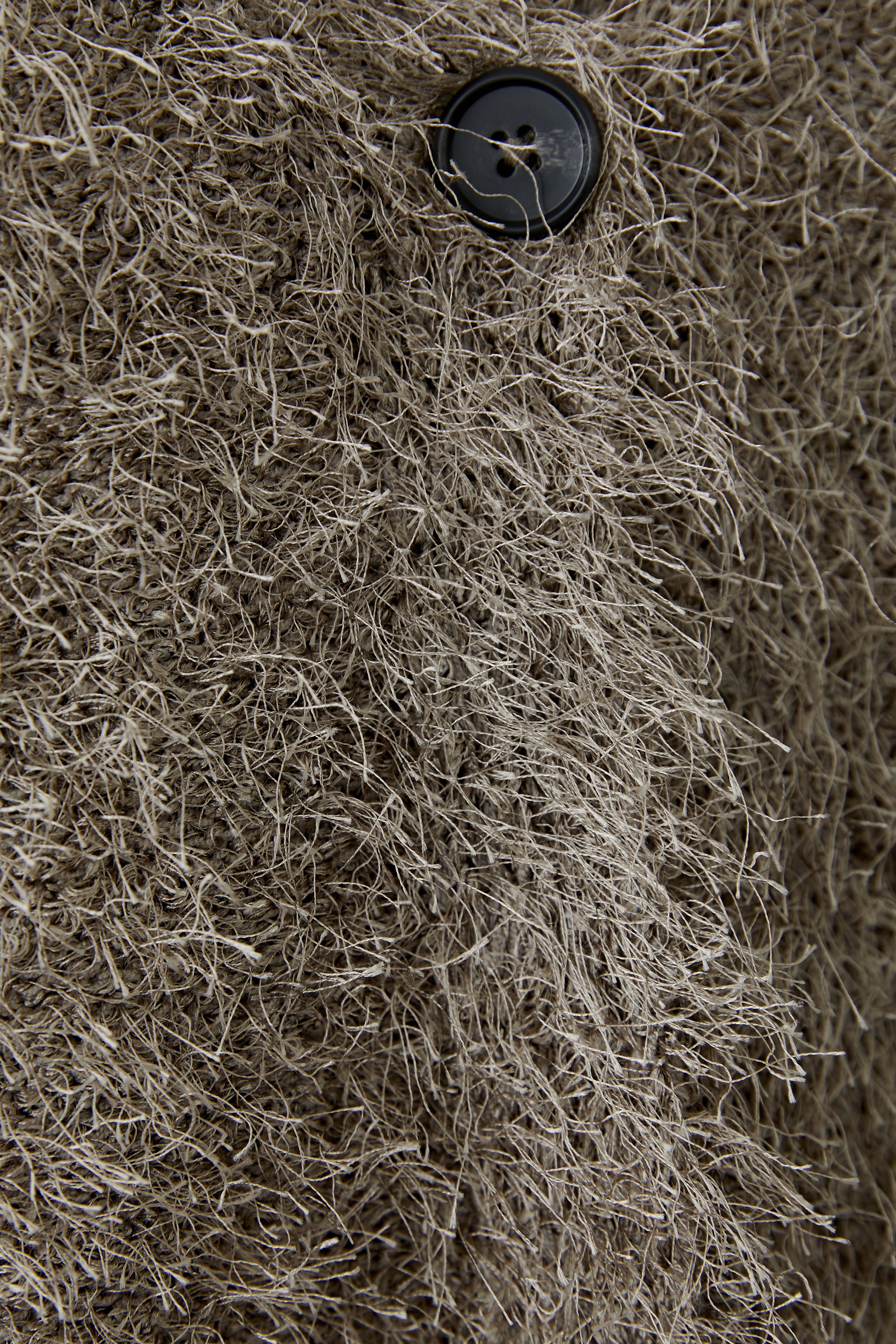Oui Smokey Taupe Fluffy Knit Cardigan close-up texture view
Detail of frayed fringed knit fabric and button fastening