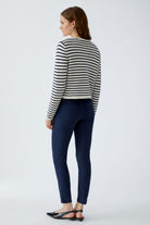 Back view of model in Oui navy/white stripe cardigan and navy trousers