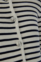 Detailed view of oui marea cardigan buttons and textured knit trim