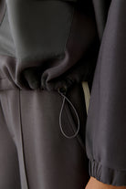 Detail of drawstring hem on Oui dark grey scuba jacket