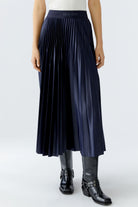 Front view of navy pleated midi skirt showing soft pleats and gloss finish