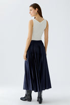 Back view of model in Oui sleeveless top and Dark blue pleated midi skirt