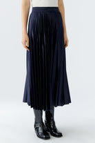 Side view of Oui pleated navy midi skirt styled casually