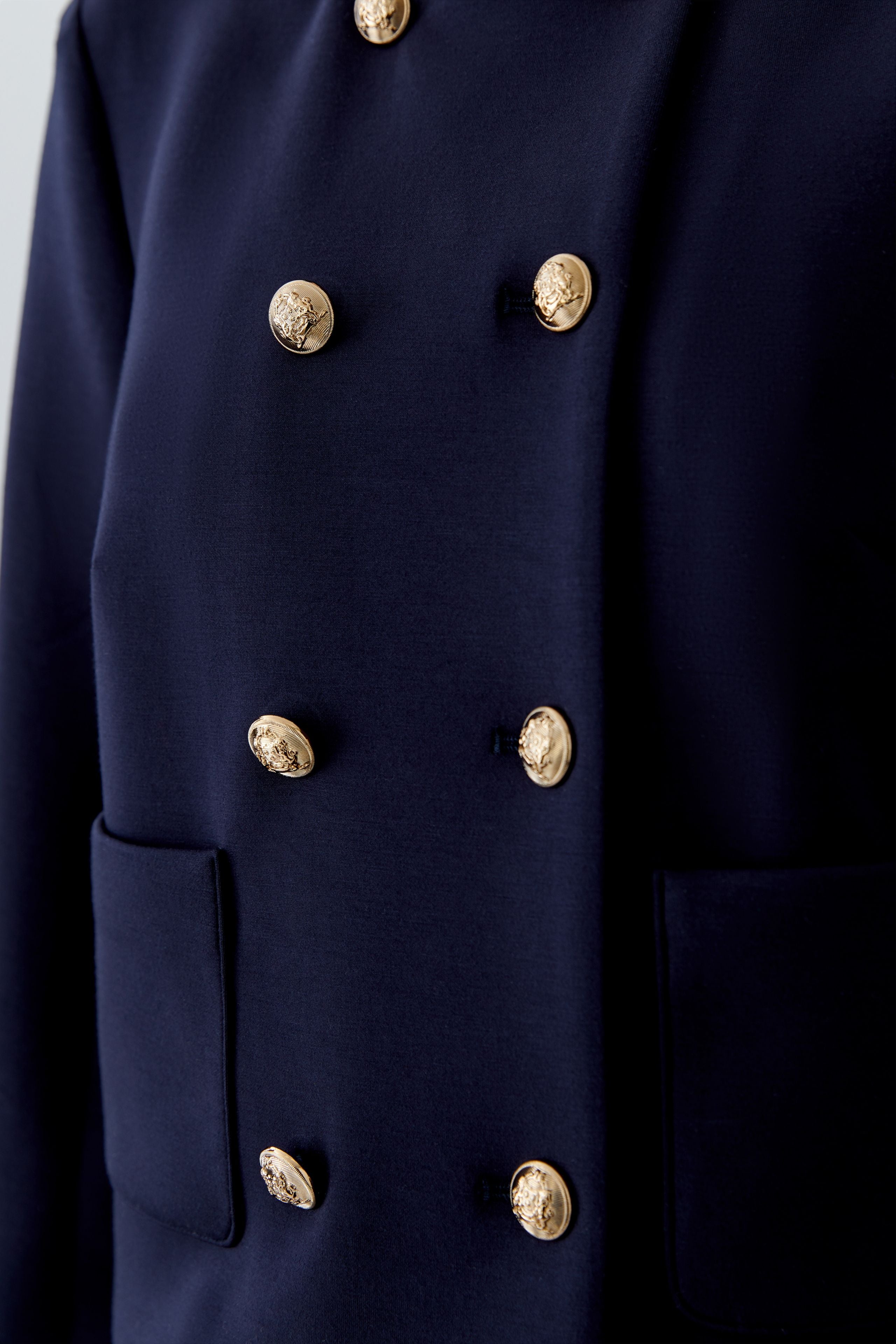 Oui crest button detail navy jacket close up