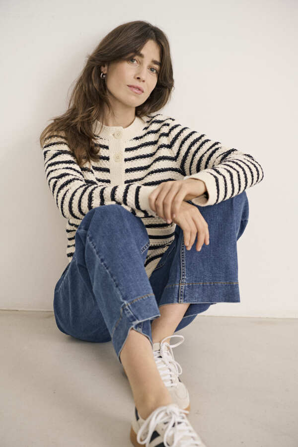 Casual striped knit cardigan paired with jeans and trainers