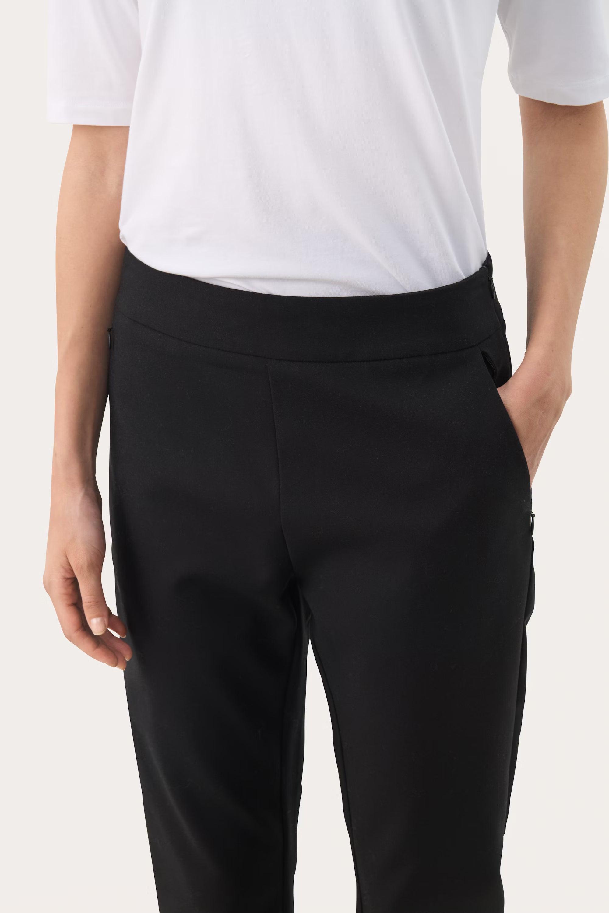 Side pocket view of slim fit Nyla trousers in black by Part Two