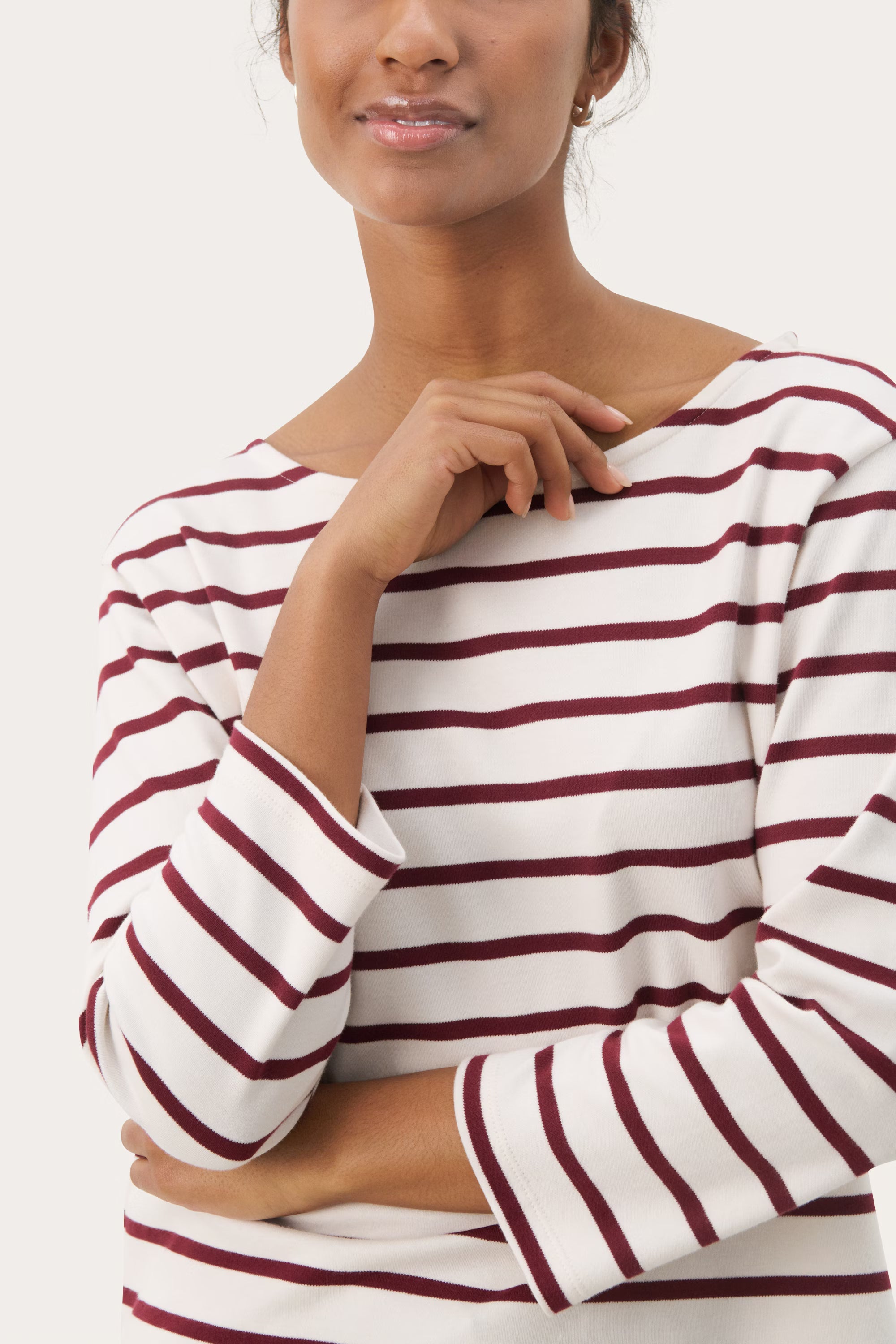 Close-up of Part Two NelaPW long-sleeved striped top in cream with burgundy stripes, styled with burgundy trousers.