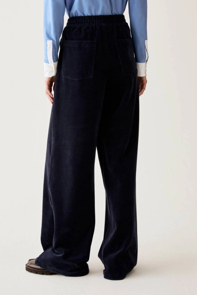 Pennyblack navy corduroy-effect joggers showing loose straight-leg fit – rear view