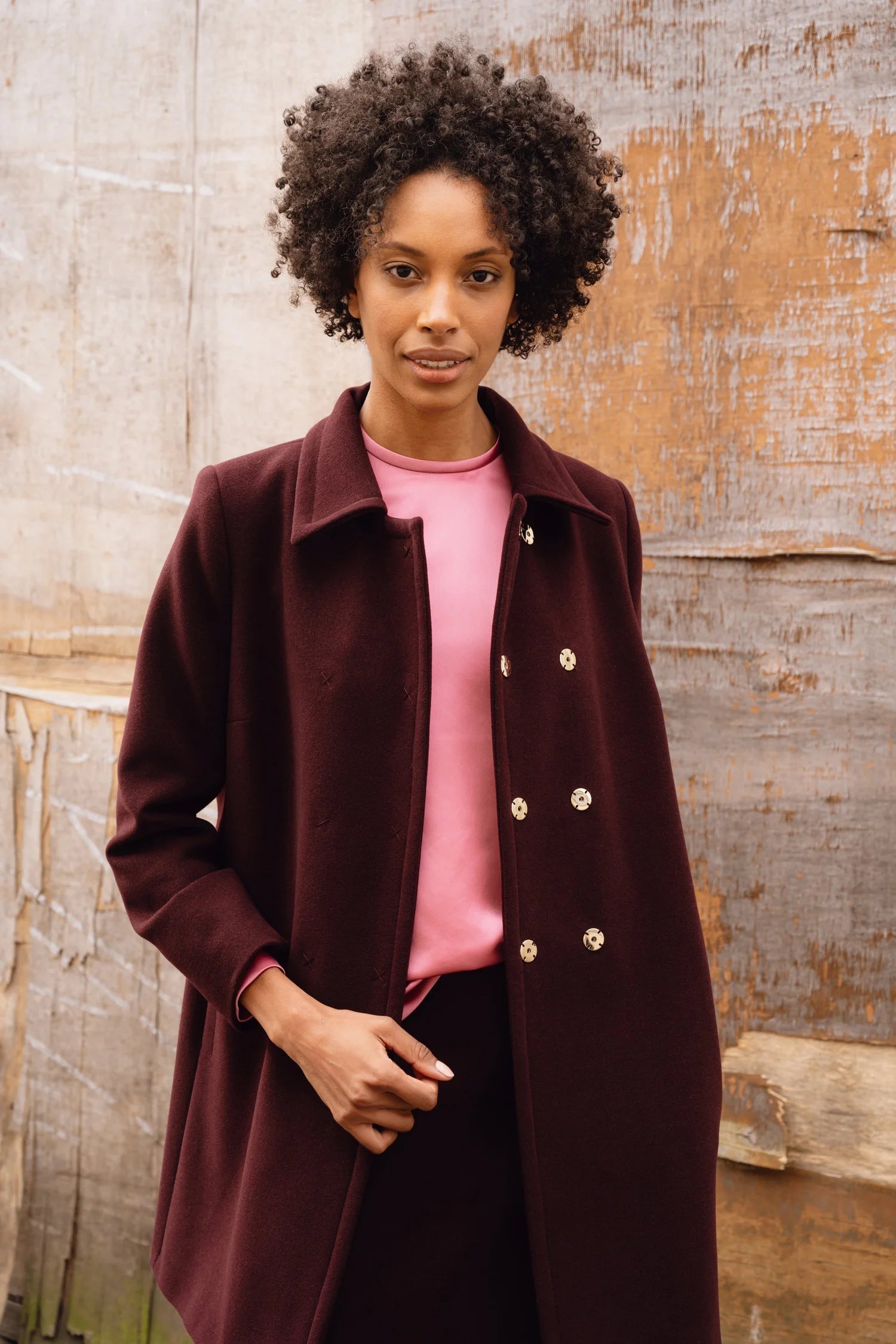 Model standing in pink satin blouse and Havana mini skirt, styled for smart daywear