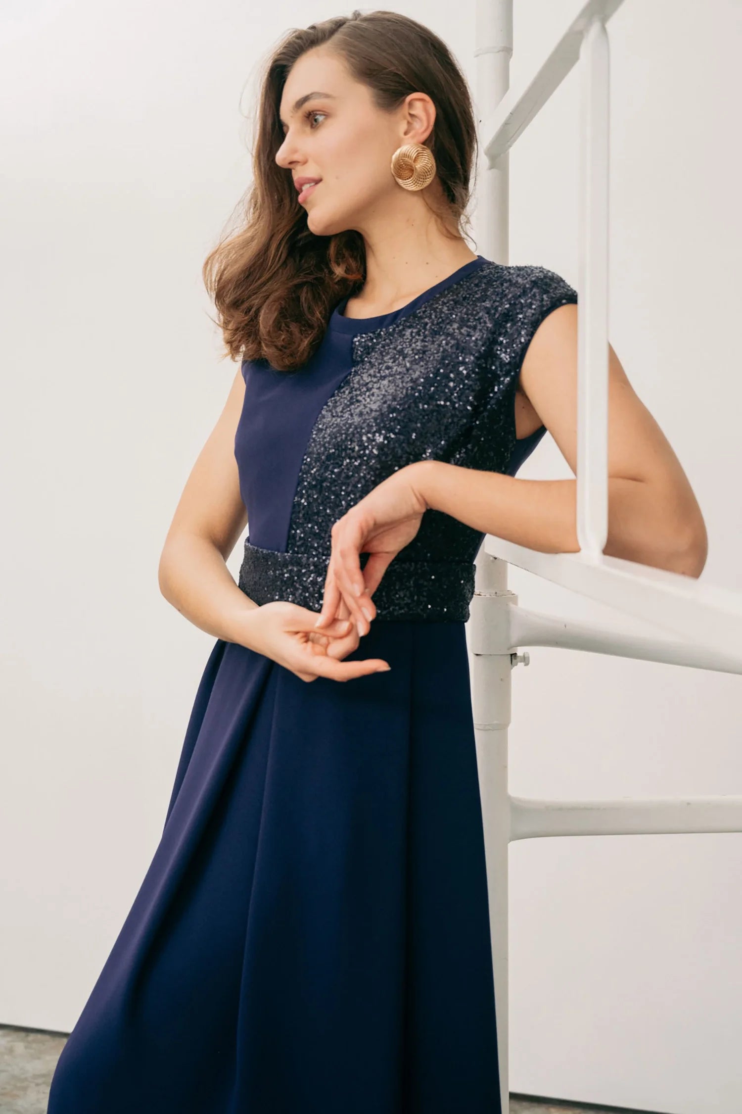 Close-up of Sisters Feya ink blue dress showing the sequin panel and defined waist