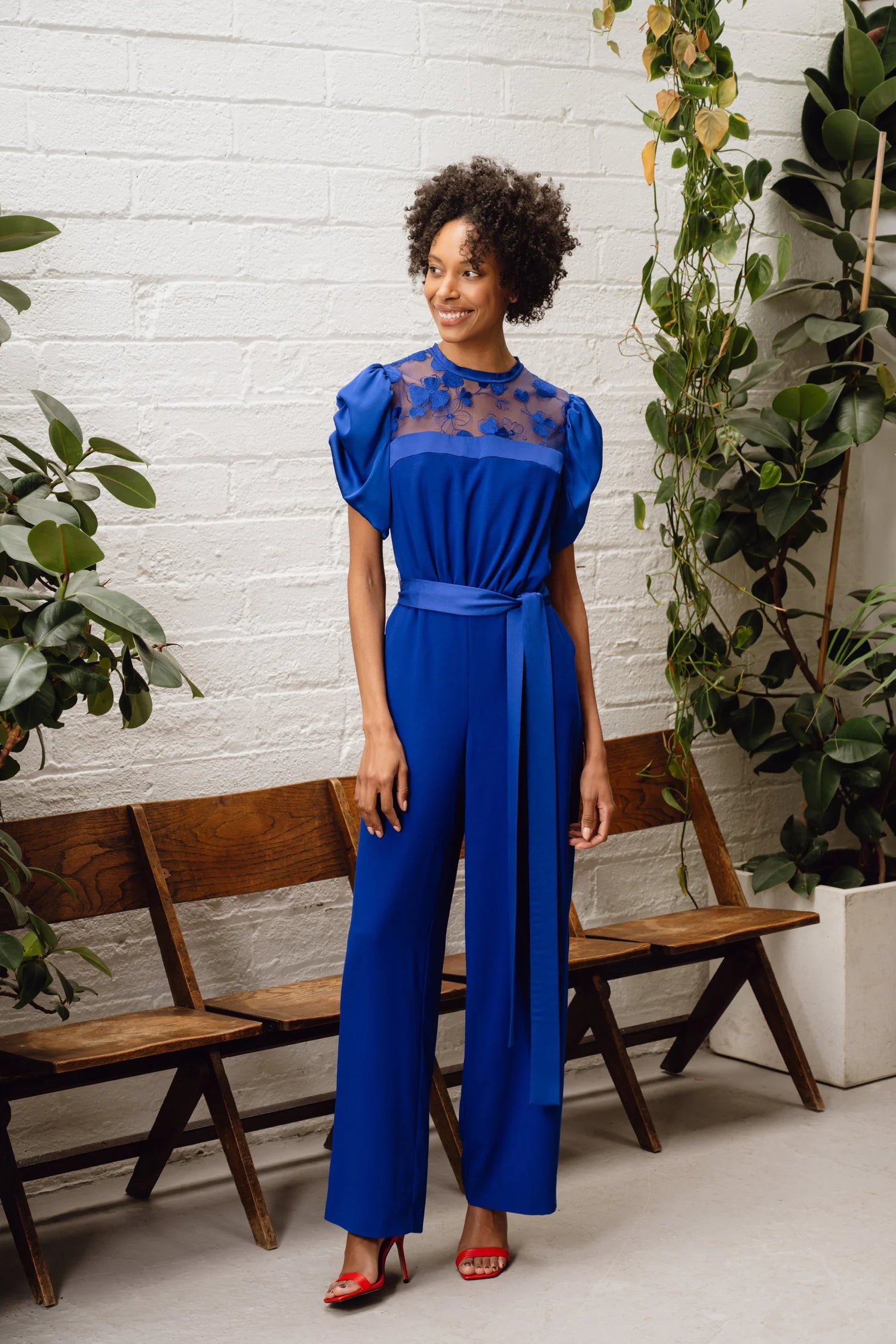 Sisters Samantha royal blue jumpsuit side view on model showing puff sleeves and wide legs
