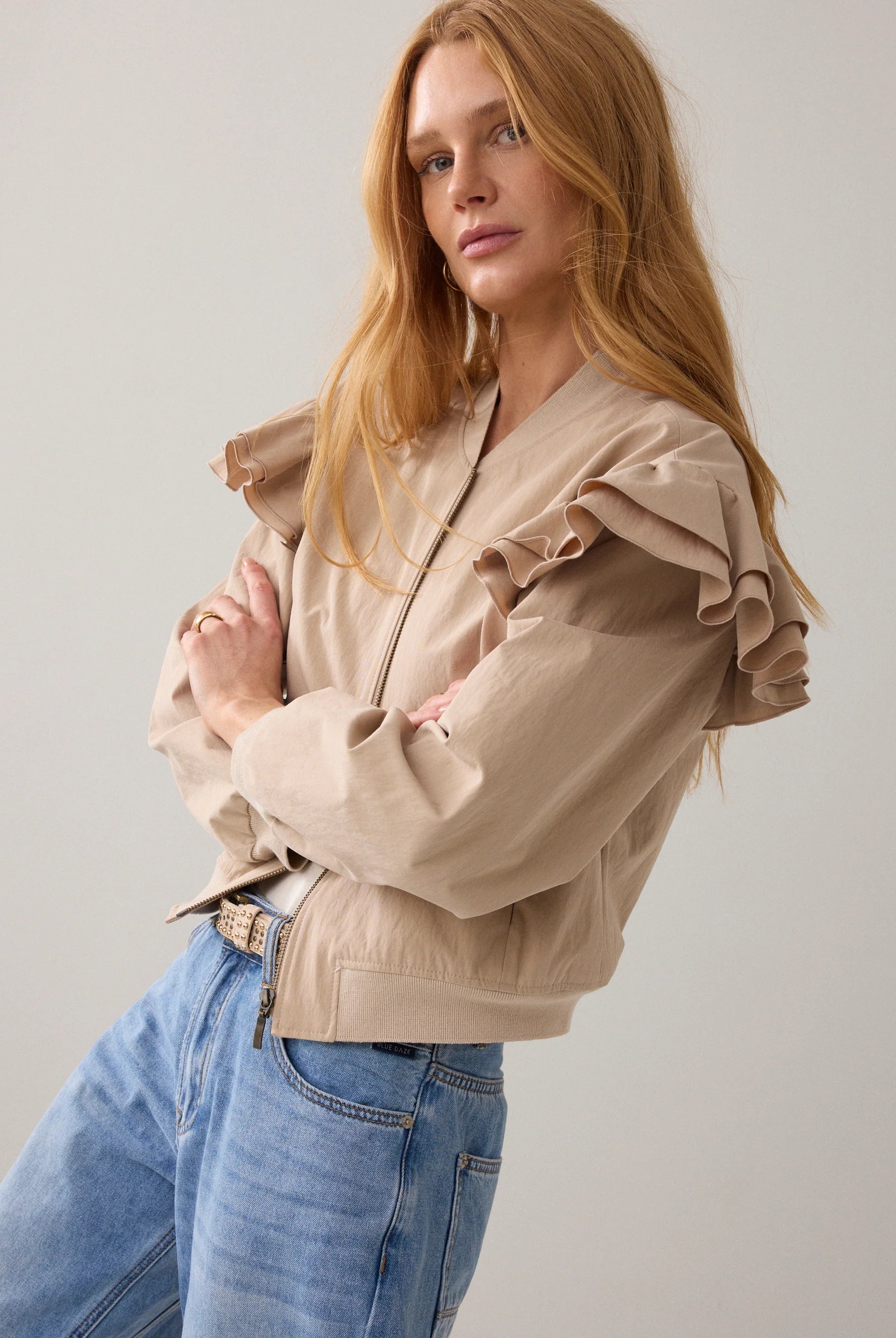 Side view of Summum bomber jacket with frill shoulder and zip front