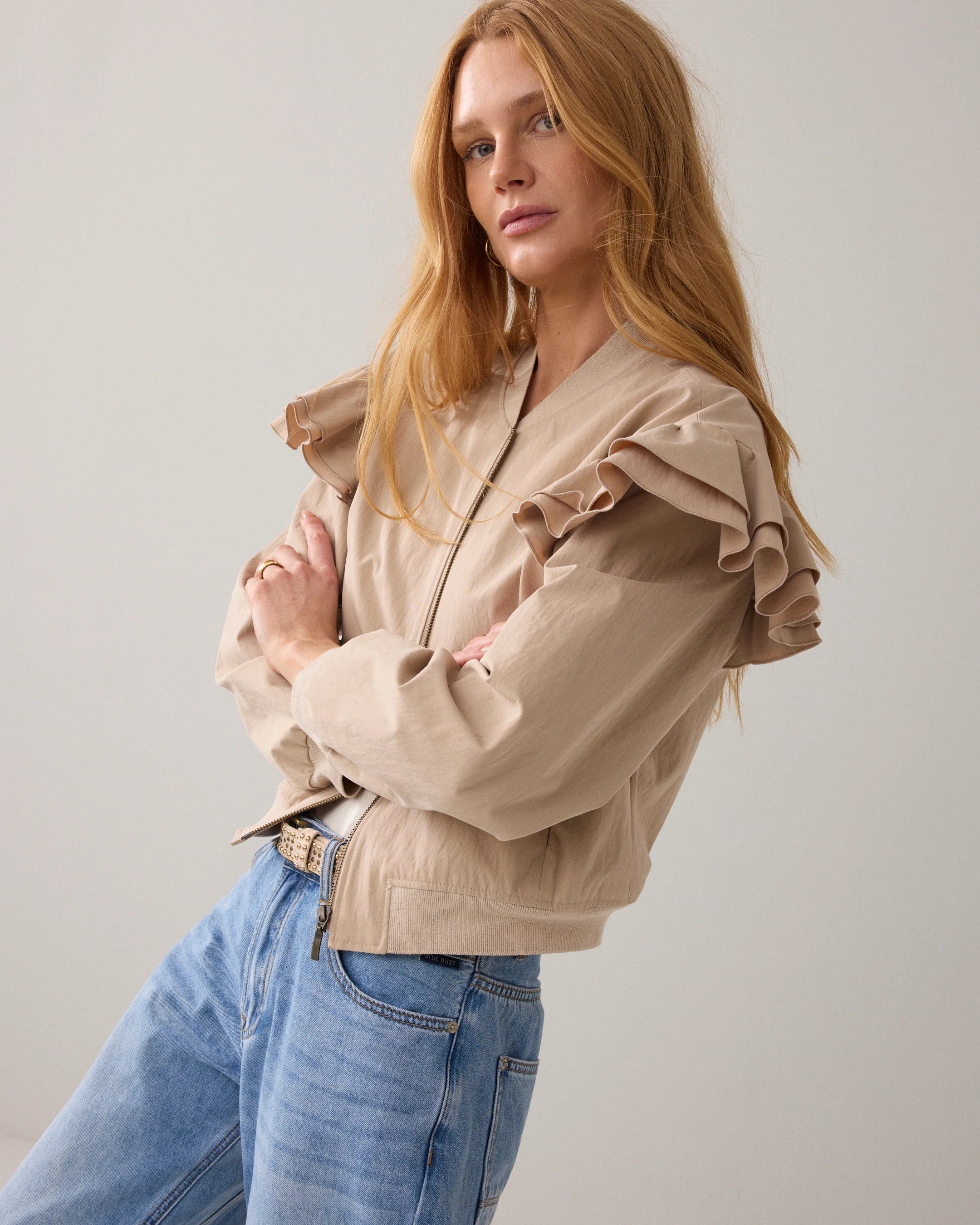 Side view of Summum bomber jacket with frill shoulder and zip front