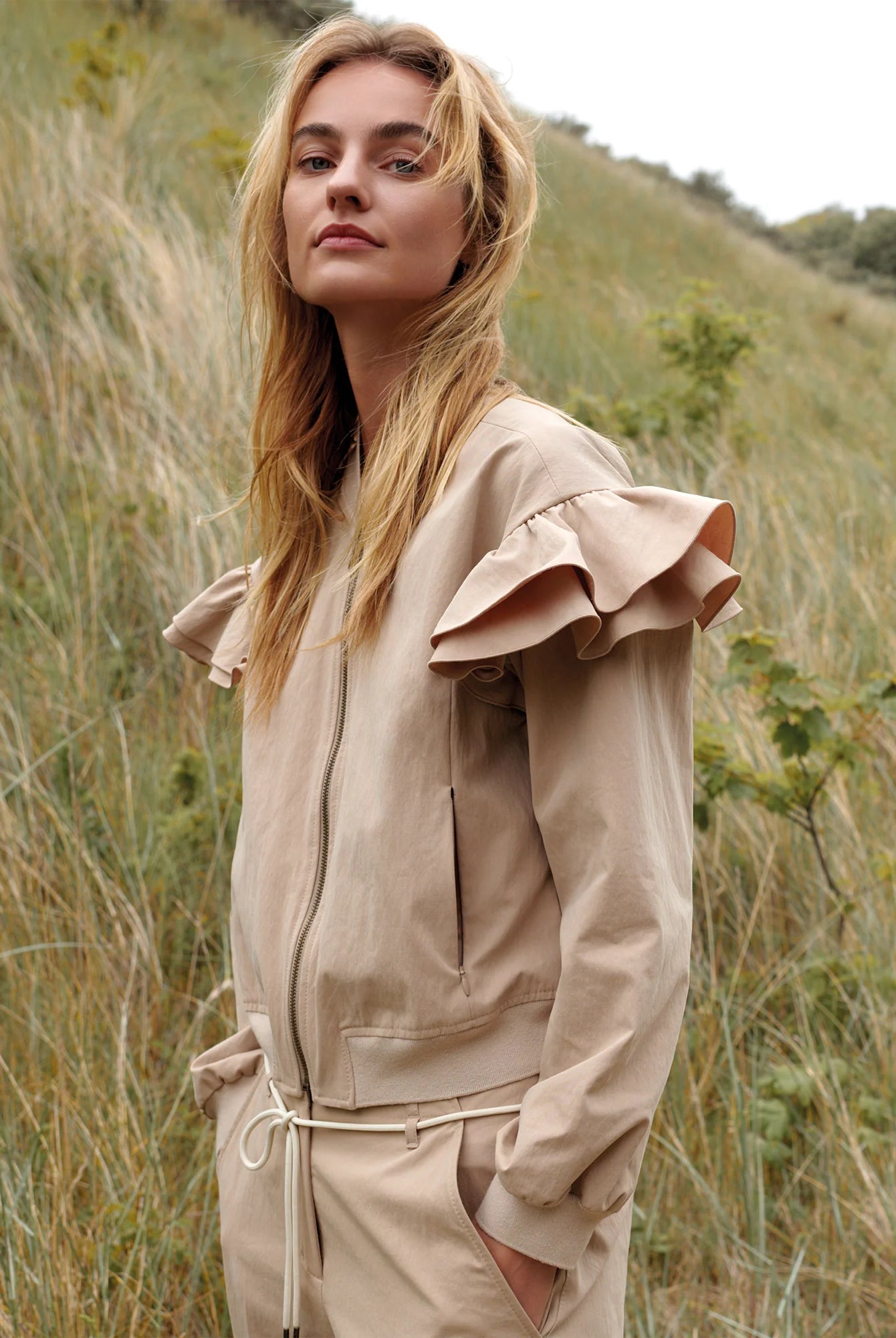 Summum frill shoulder bomber jacket styled outdoors, side profile