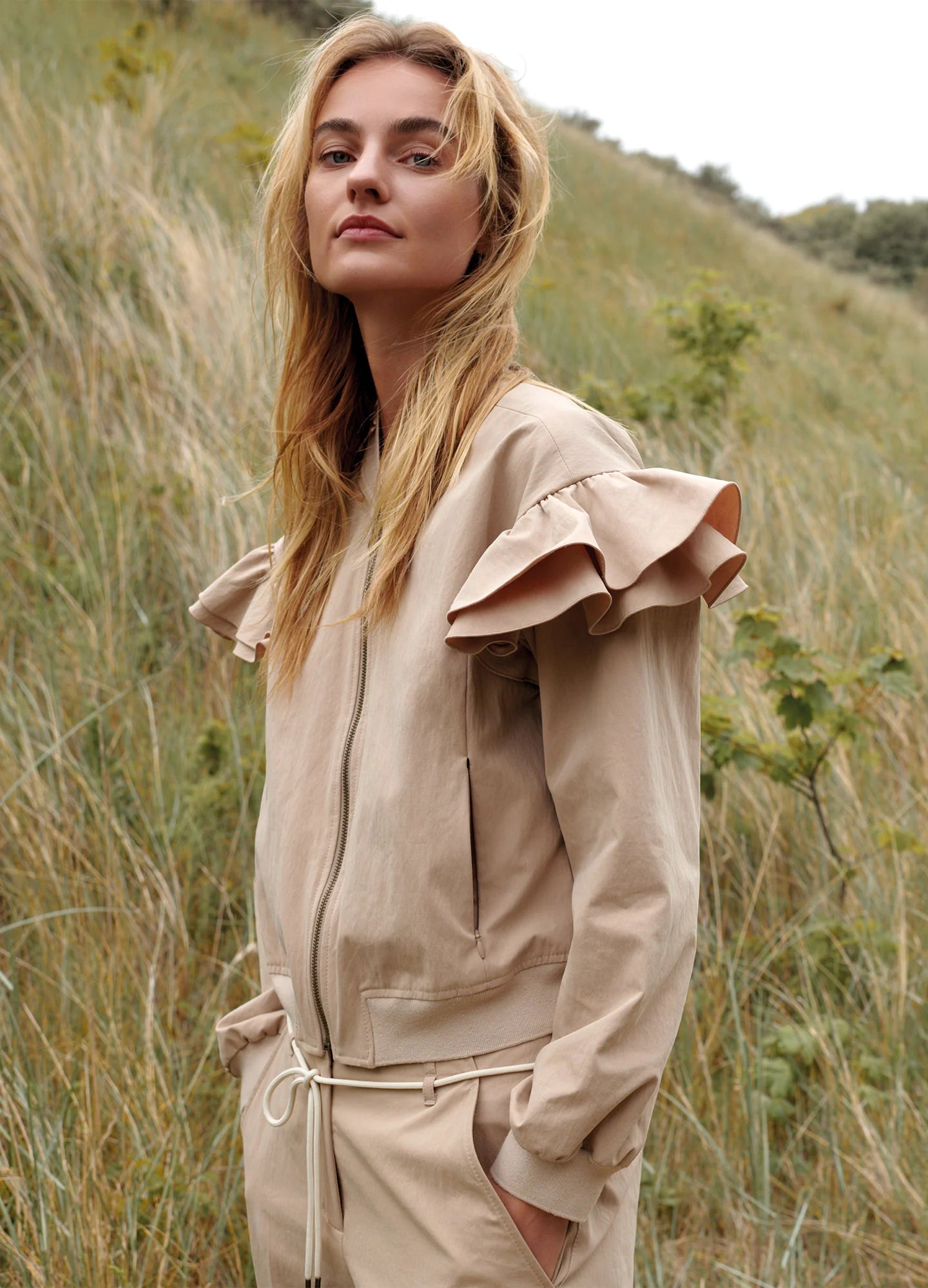 Summum frill shoulder bomber jacket styled outdoors, side profile