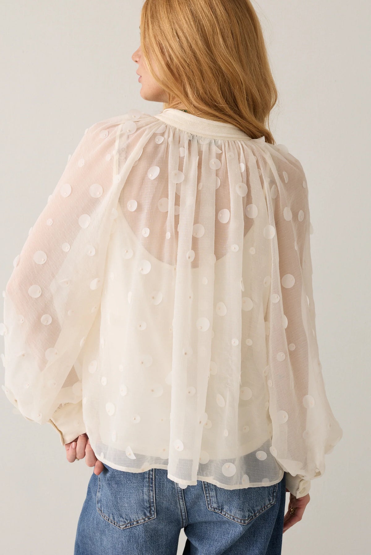 Summum cream sheer blouse – back model view showing flared shape