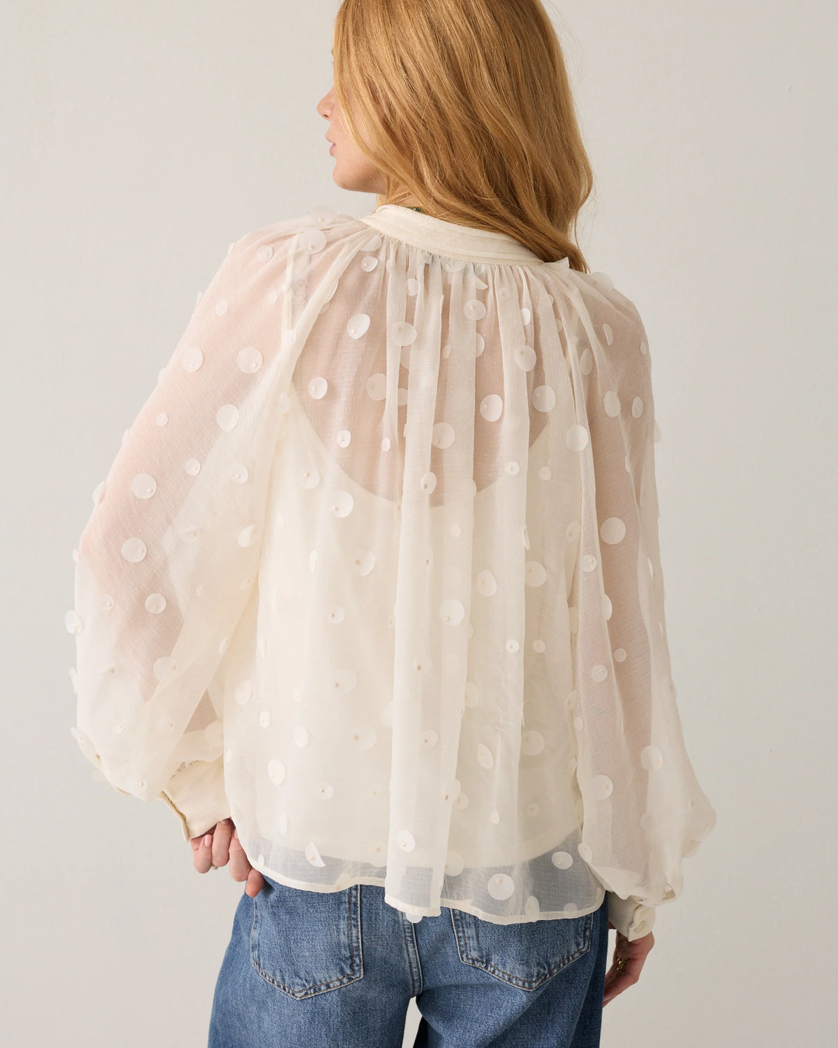 Summum cream sheer blouse – back model view showing flared shape