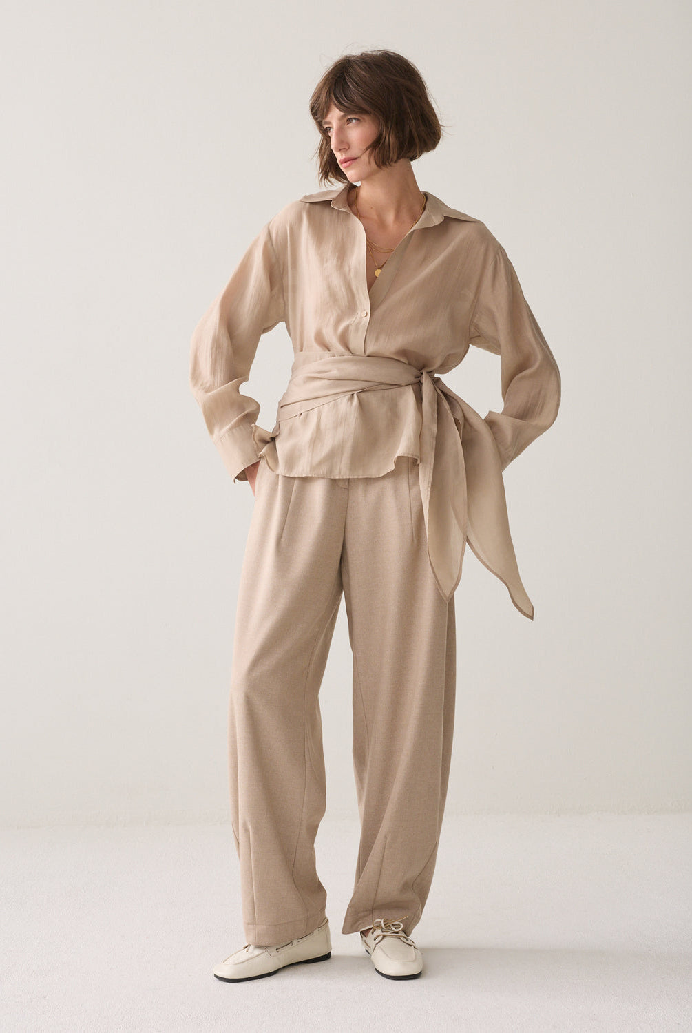 Women’s Summum sand wrap blouse styled with matching beige trousers