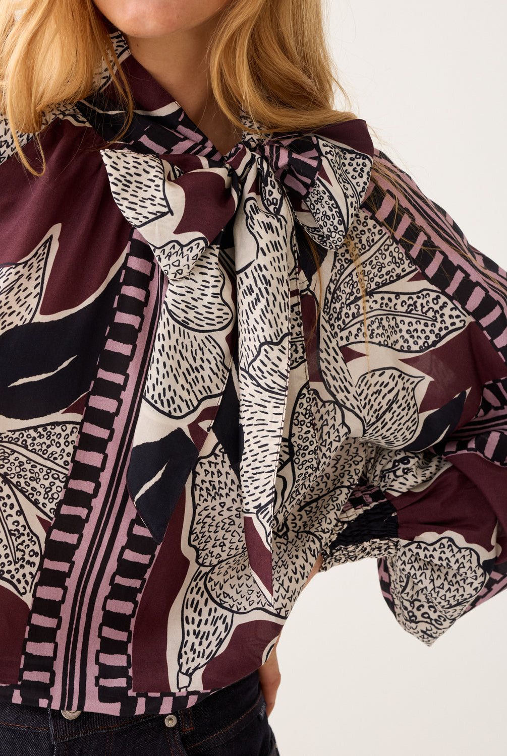 Close-up of Summum floral bow blouse neckline and print