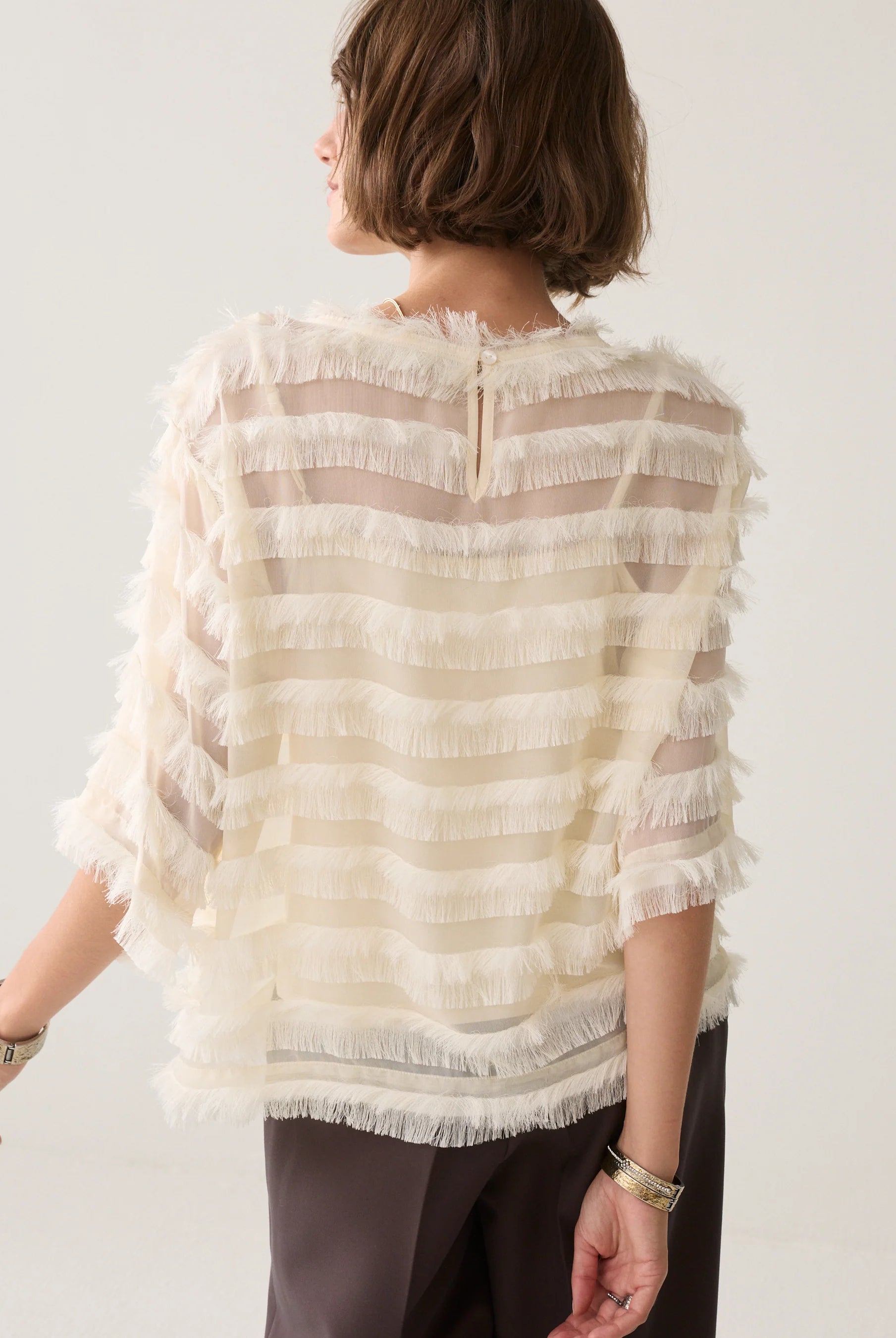 Summum cream fringed top back view with button fastening