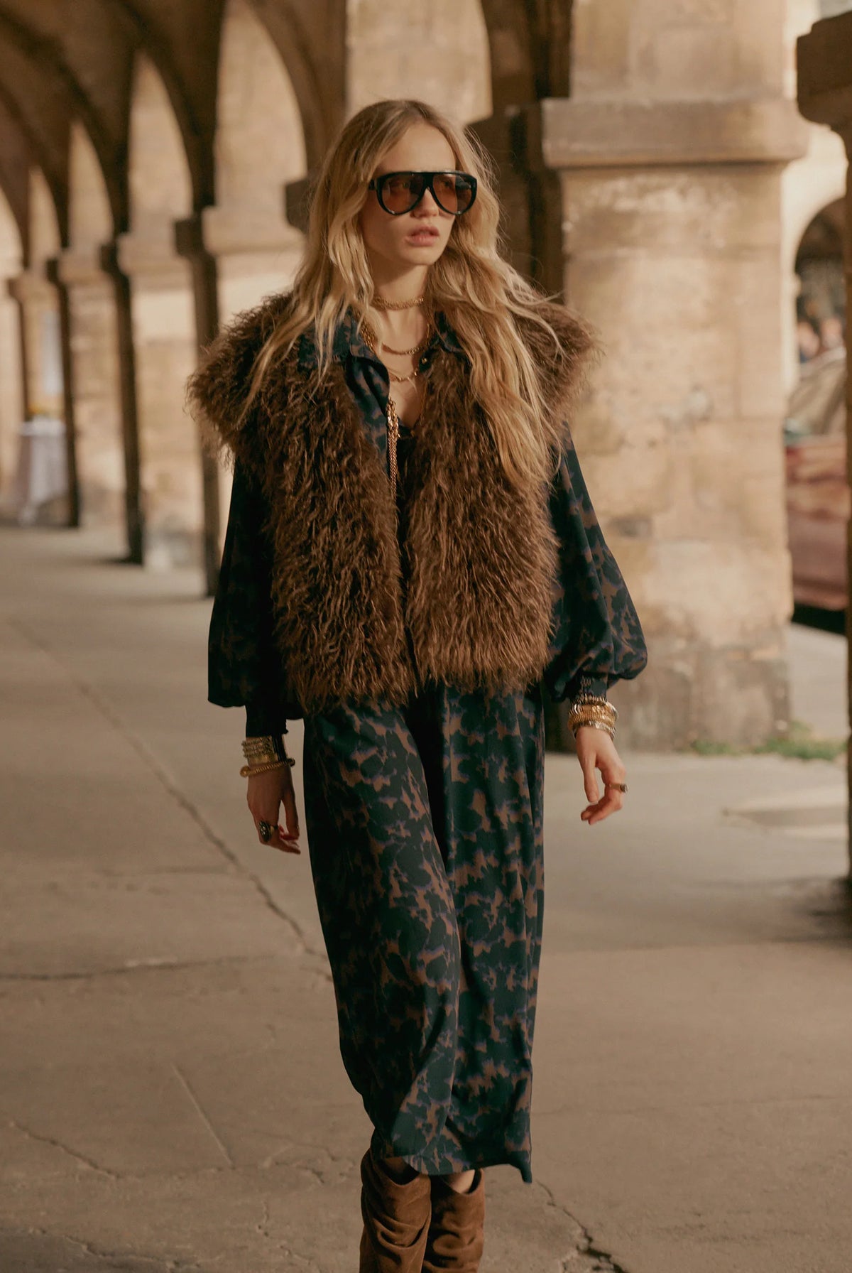 Summum camouflage print midi dress layered with a brown faux-fur gilet – outdoor lifestyle view