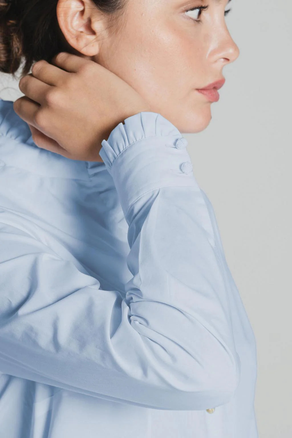Cuff detail of light blue Tinta Lucar frill shirt with button fastening