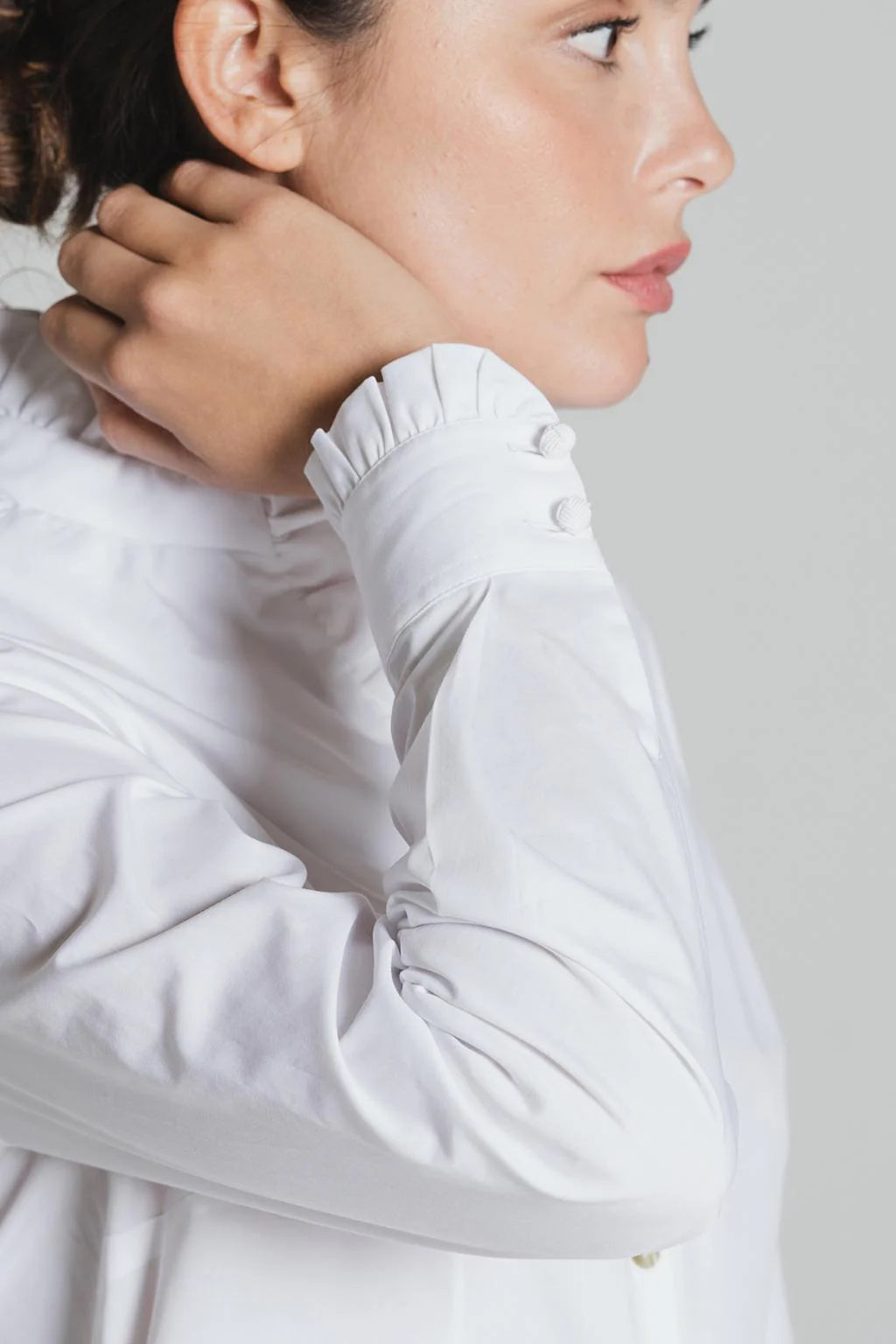 Cuff detail of white Tinta Lucar frill shirt with fabric buttons