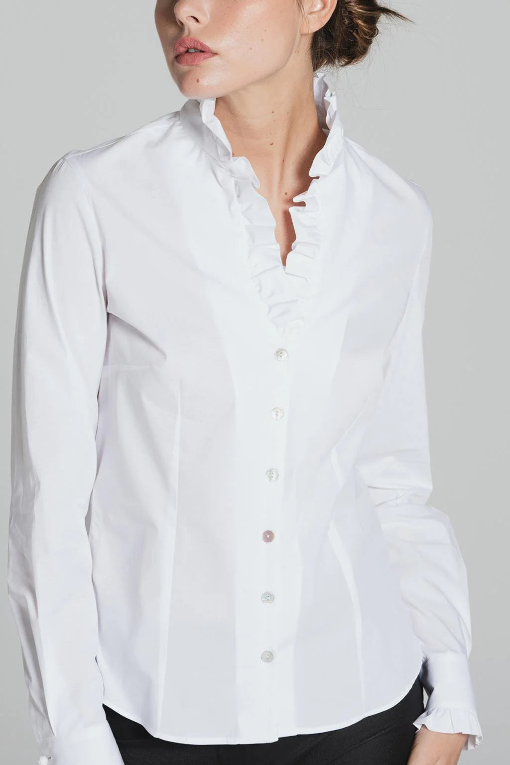 Close-up of ruffled neckline on white Tinta Lucar frill shirt