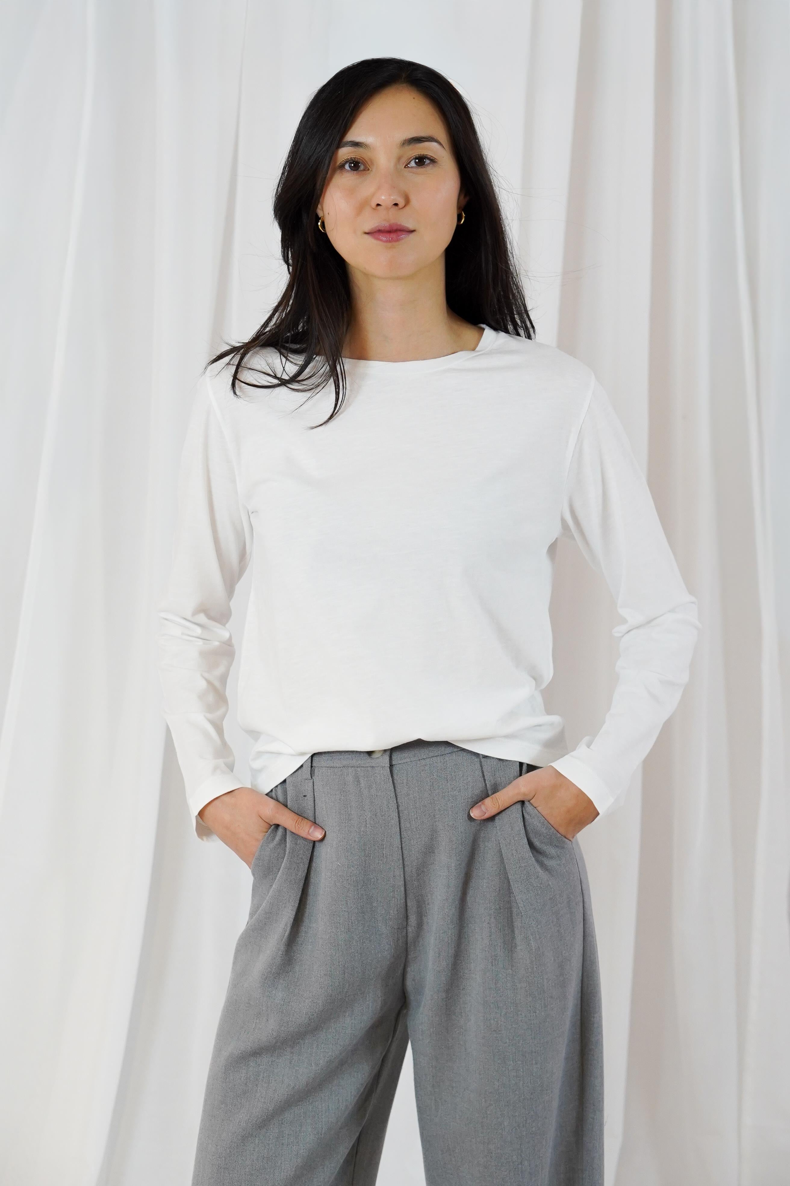Twins Queens white fitted cotton long sleeve T-shirt styled with grey trousers