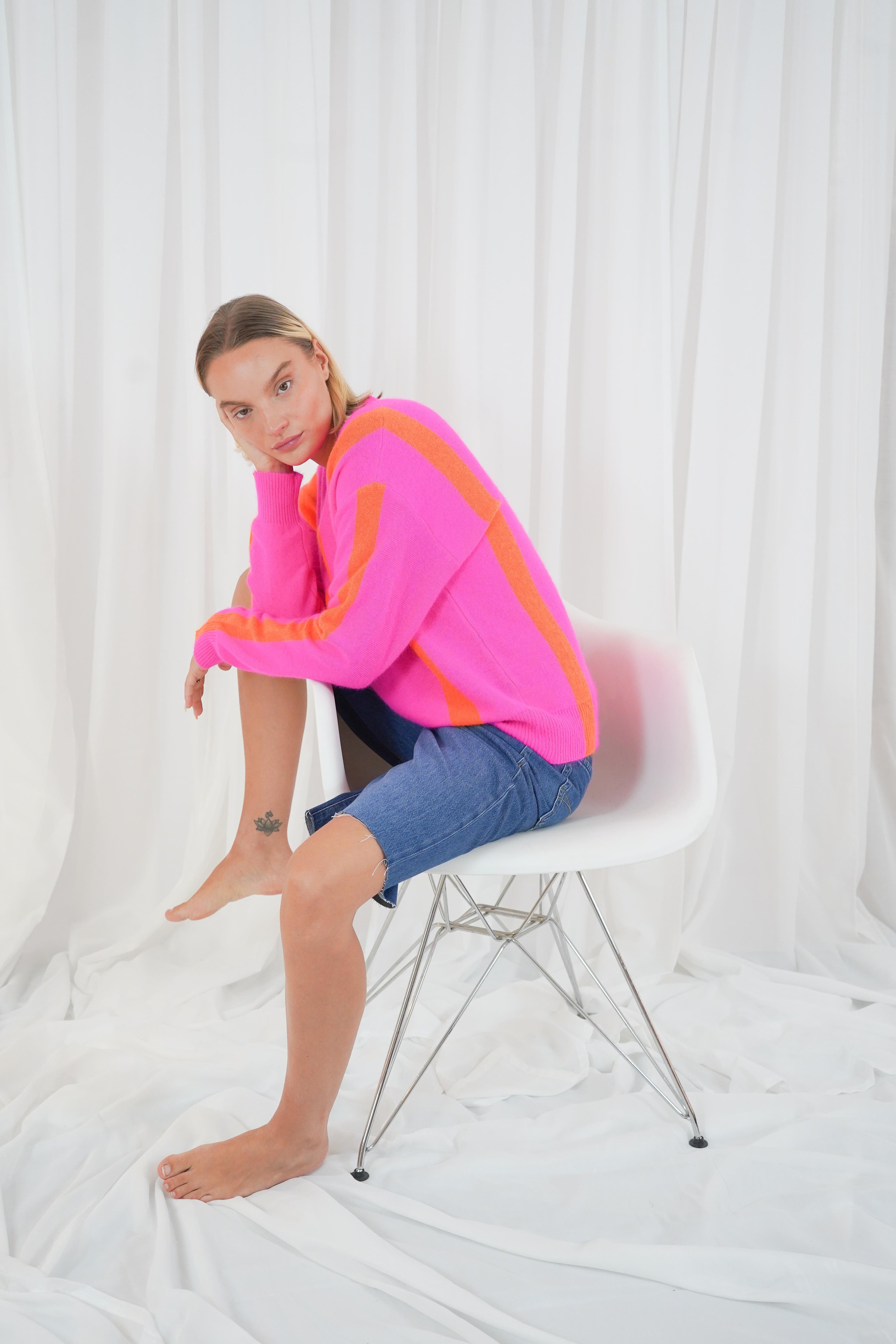 Twins Reno soft striped crew neck jumper shown in a seated side view