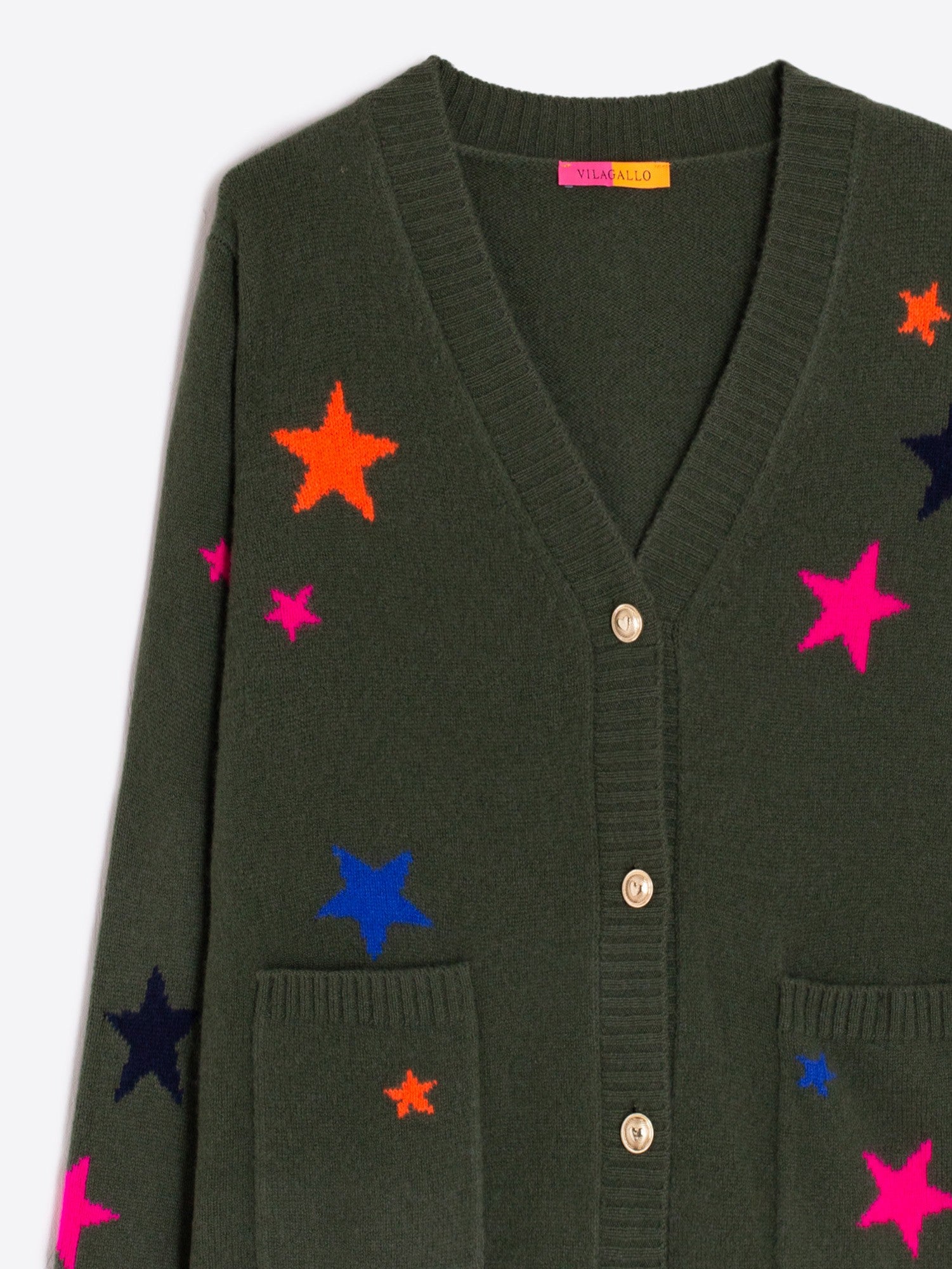 Close-up of neon stars on Vilagallo Alina green cardigan