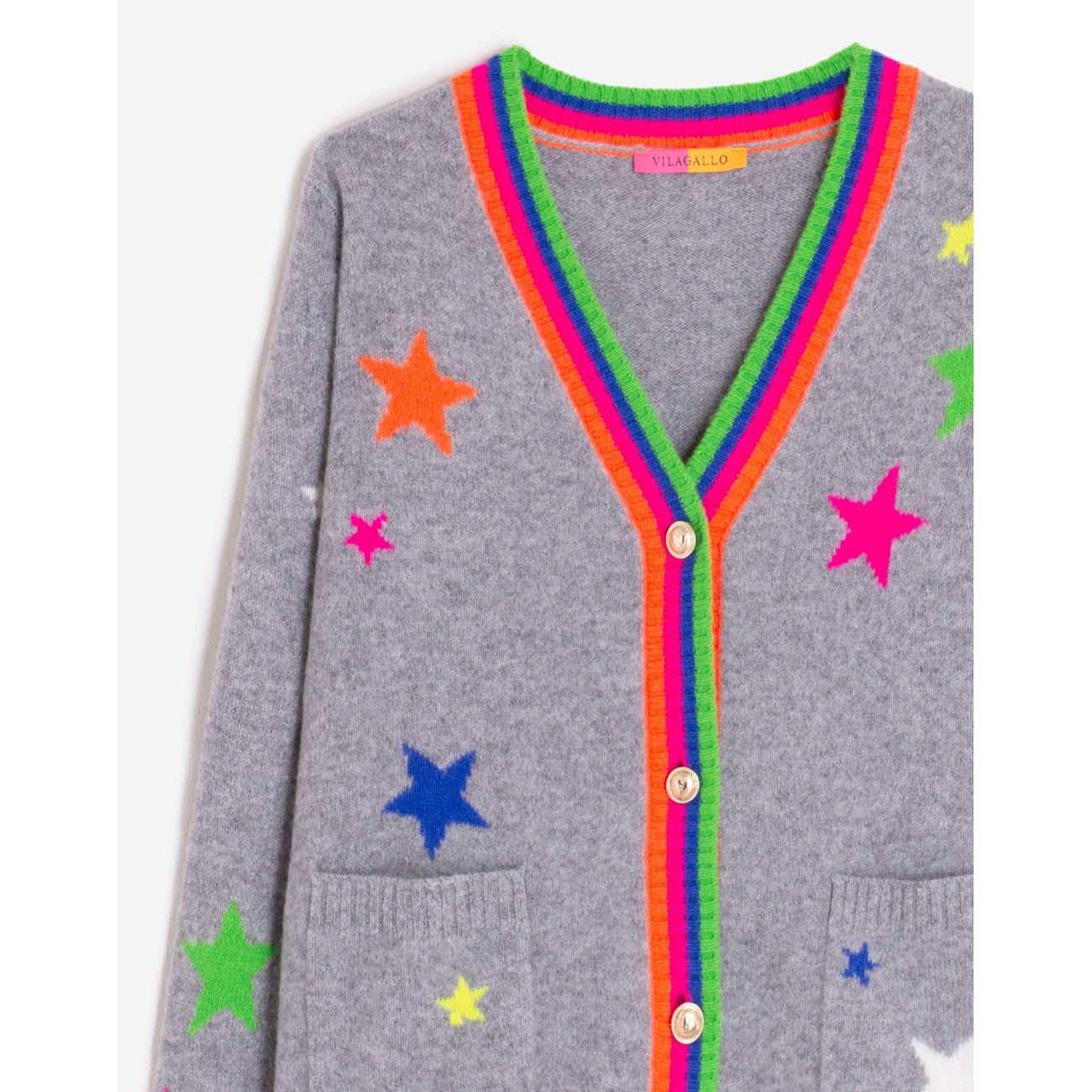 Close-up of rainbow trim and colourful stars on Vilagallo Grey wool cardigan