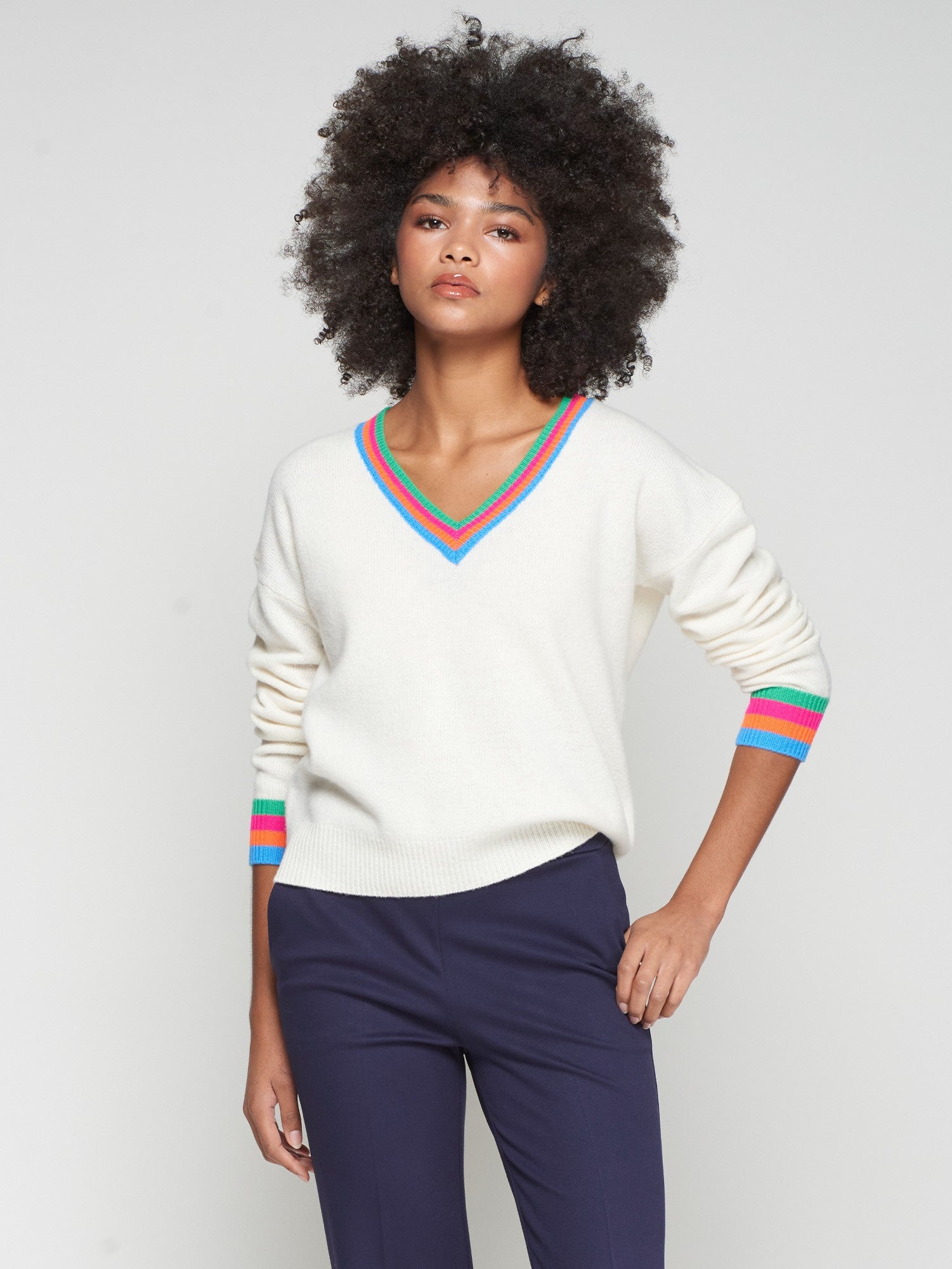 Vilagallo cream wool jumper with bold multicolour V-neckline and striped cuffs.