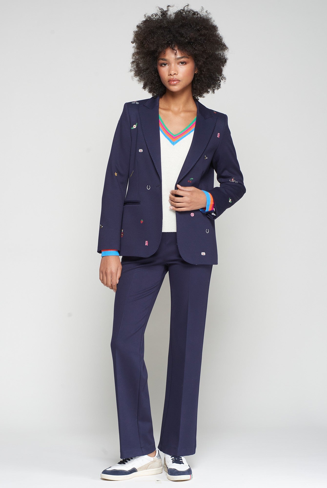 Vilagallo Matching navy blazer and straight-leg trousers styled with trainers.